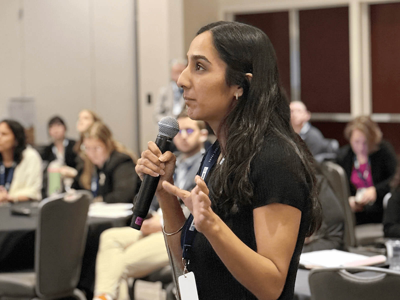 A woman speaks in a microphone