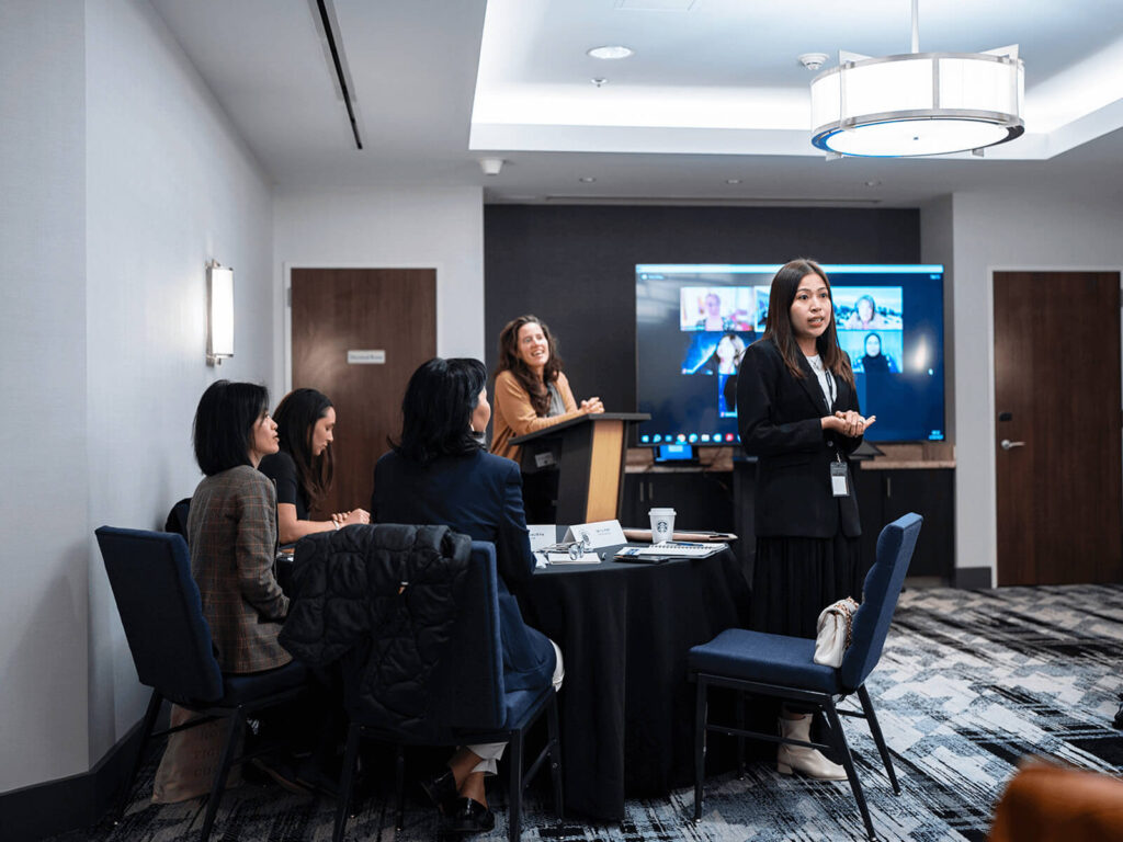 A group of women listening to a woman speak