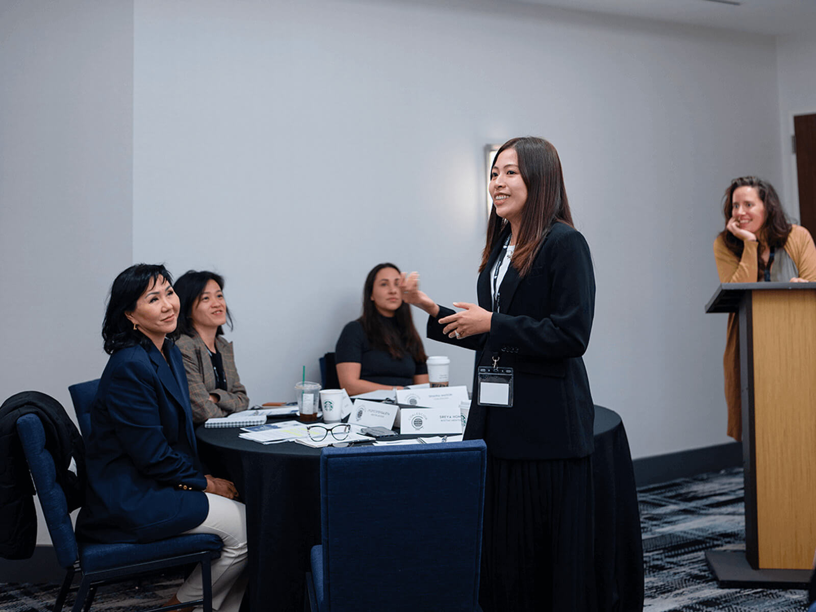 A group of women listening to a woman speak